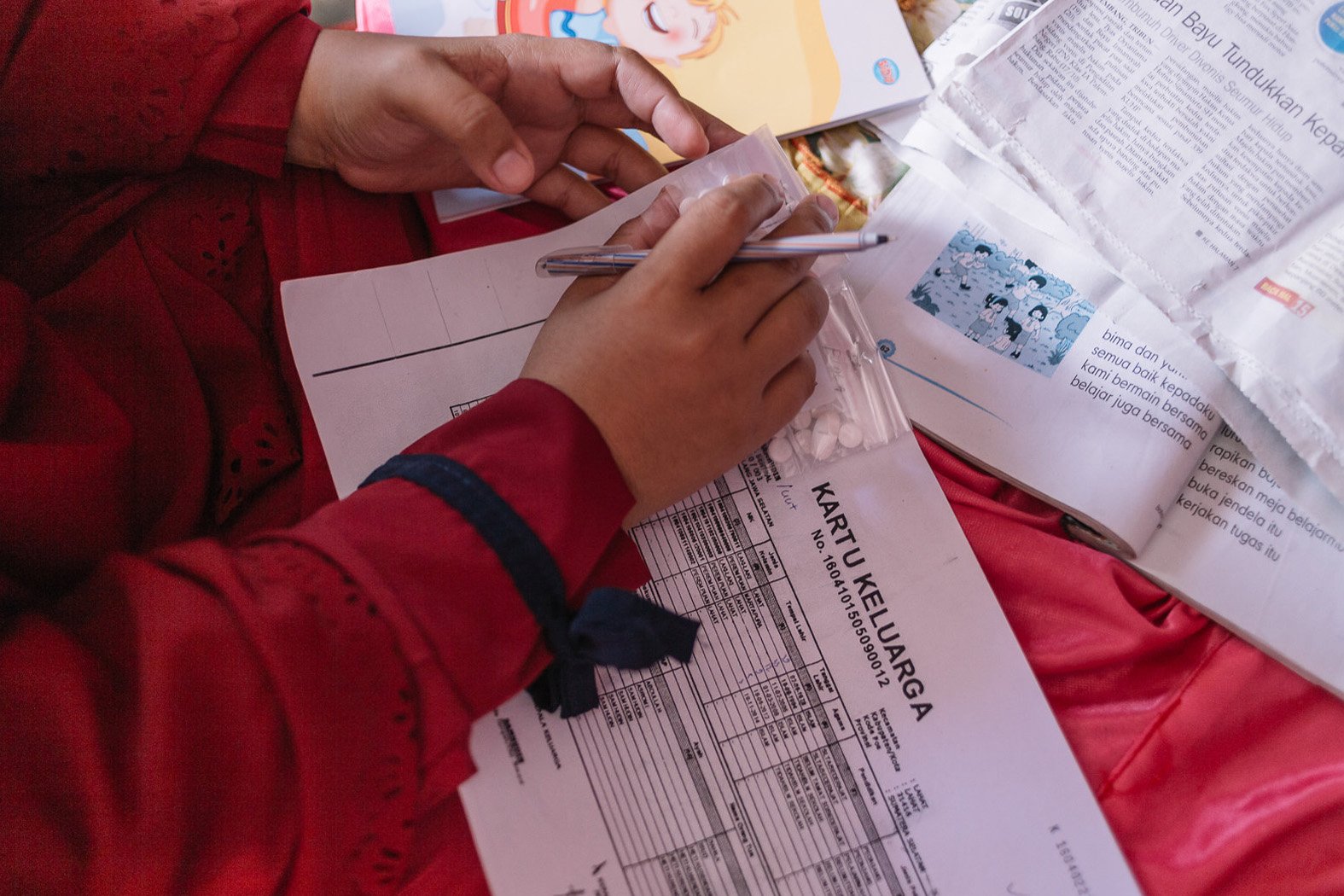 A health worker in South Sumatra records and reviews information during a mass drug administration for the elimination of lymphatic filariasis in South Sumatra.